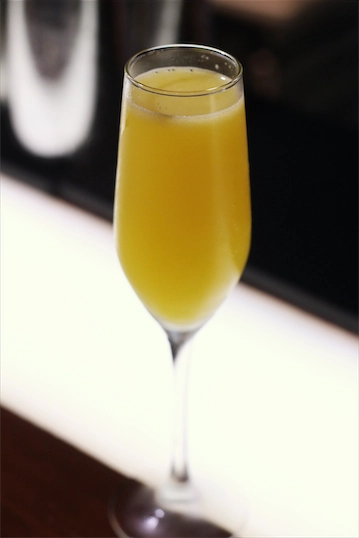 Peach Mamosa - booze poured over a sweet peach puree. Mimosa is beautiful drink anytime of the day.